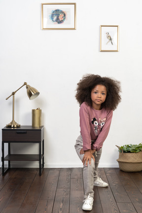 Cute girl kid posing on the apartments background