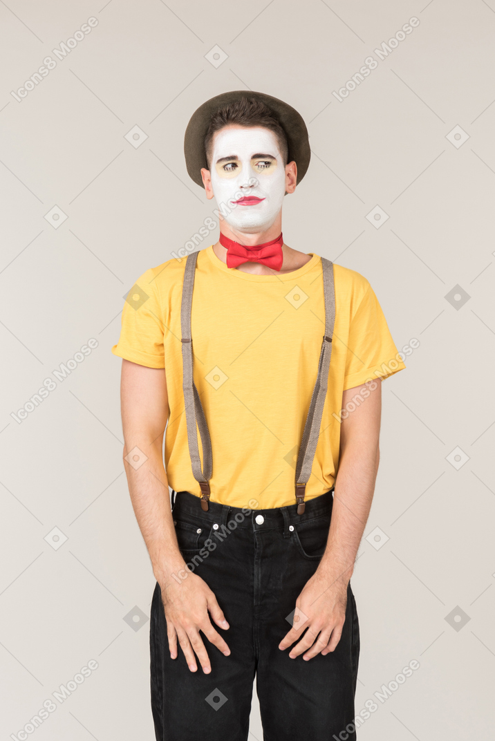 Male clown standing with his hands elongated