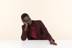 Elegant black man sitting at the table in the office