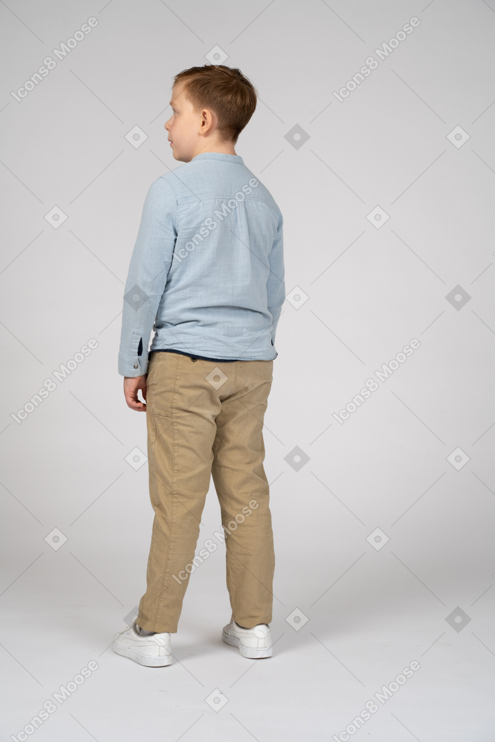 Back view of a boy looking aside
