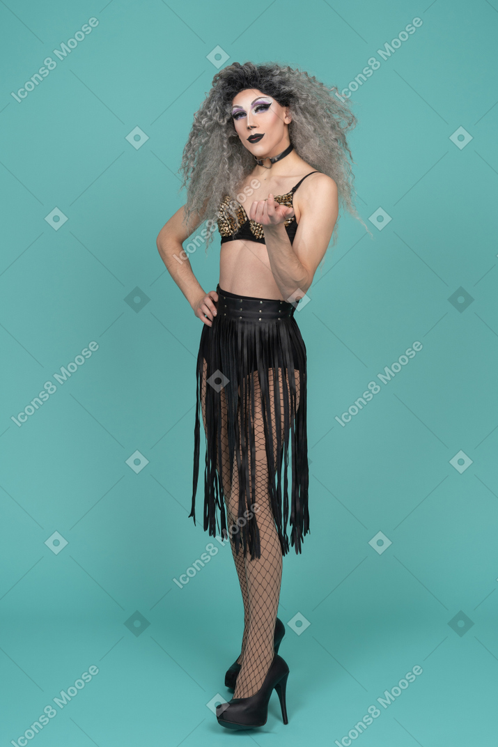 Drag queen in all black outfit beckoning