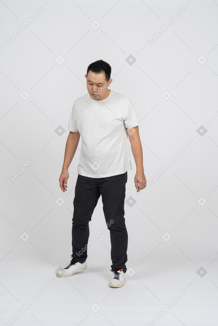 Front view of a confused man looking down