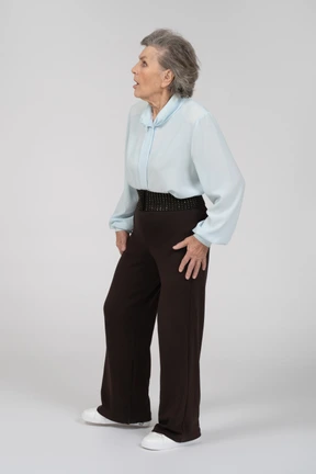 Three-quarter view of an old woman looking scaredly to the left