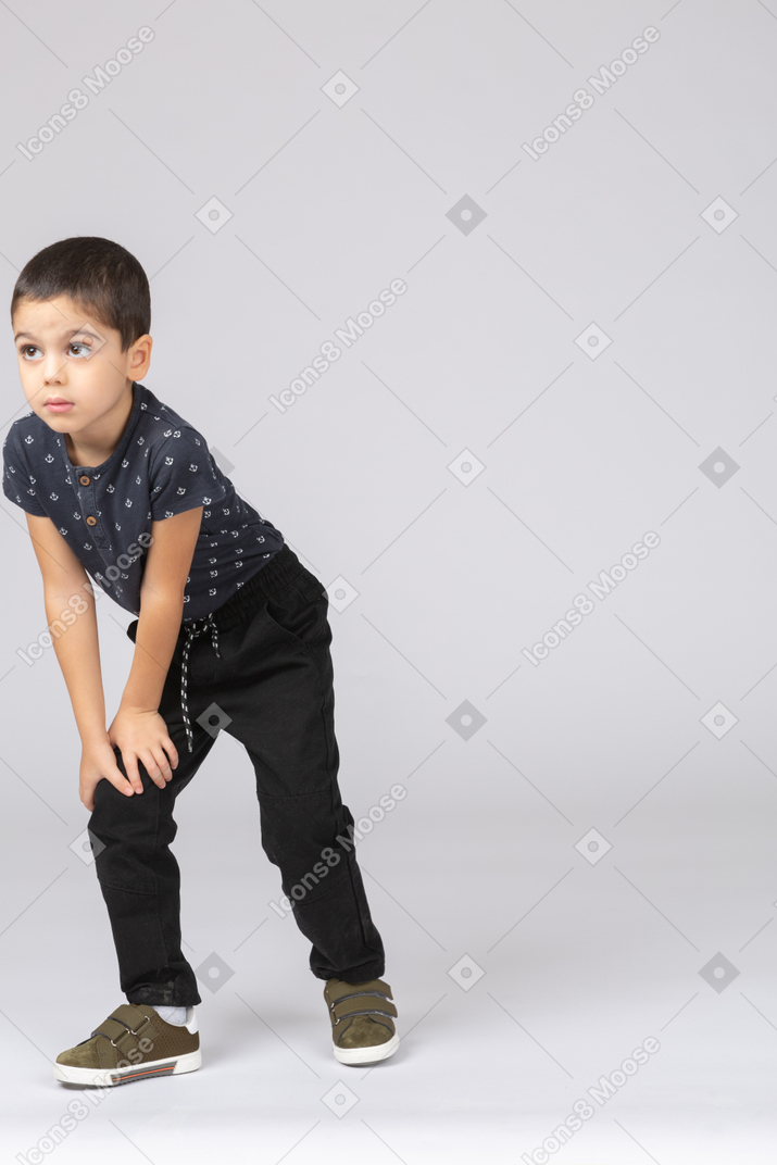 Front view of a cute boy making a lunge