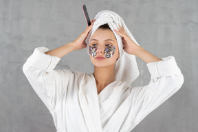 Confident-looking woman adjusting her hair towel