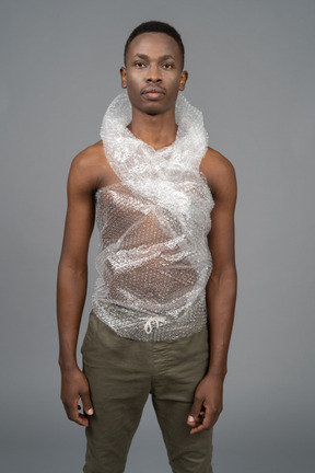 Serious african man wrapped in plastic