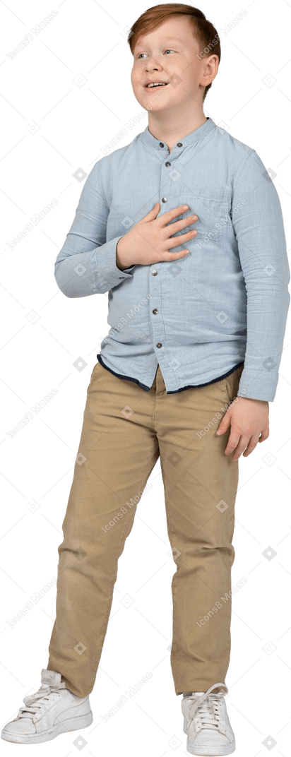 Front view of a cute boy posing with hand on chest
