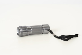 Silver flashlight on a white background