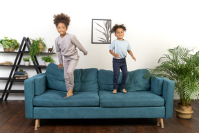 Good looking boy and girl play on the sofa