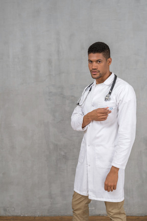 Male doctor touching his coat's pocket