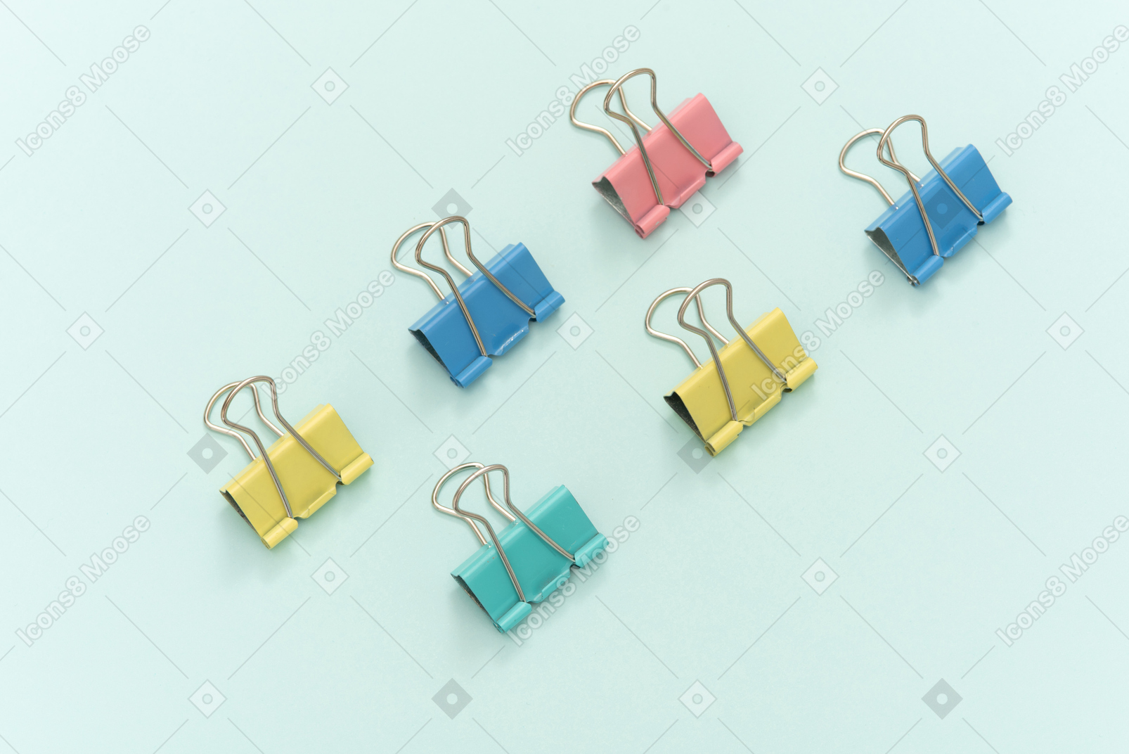 Colourful paper clips on blue background