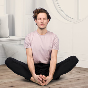 A man sitting in a lotus position on a wooden floor