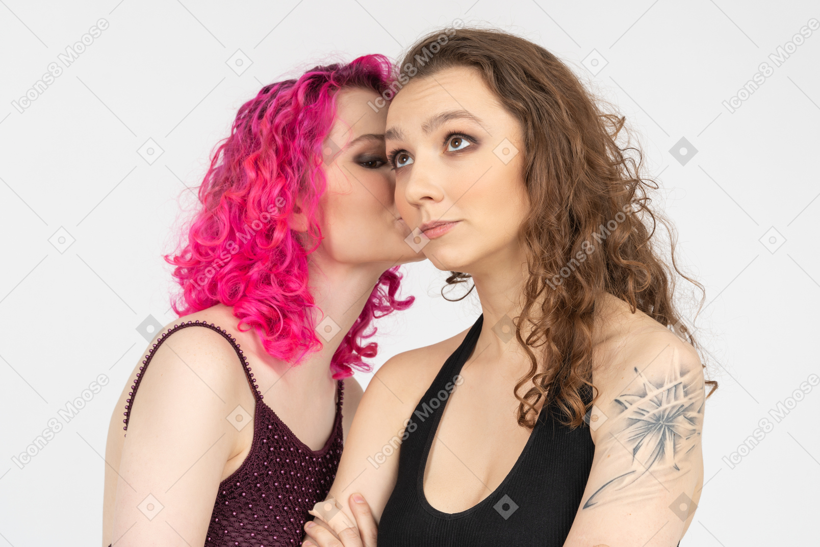Pink haired girl whispering in brown haired girl ear