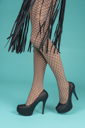 Side view of legs in fishnets and high heels