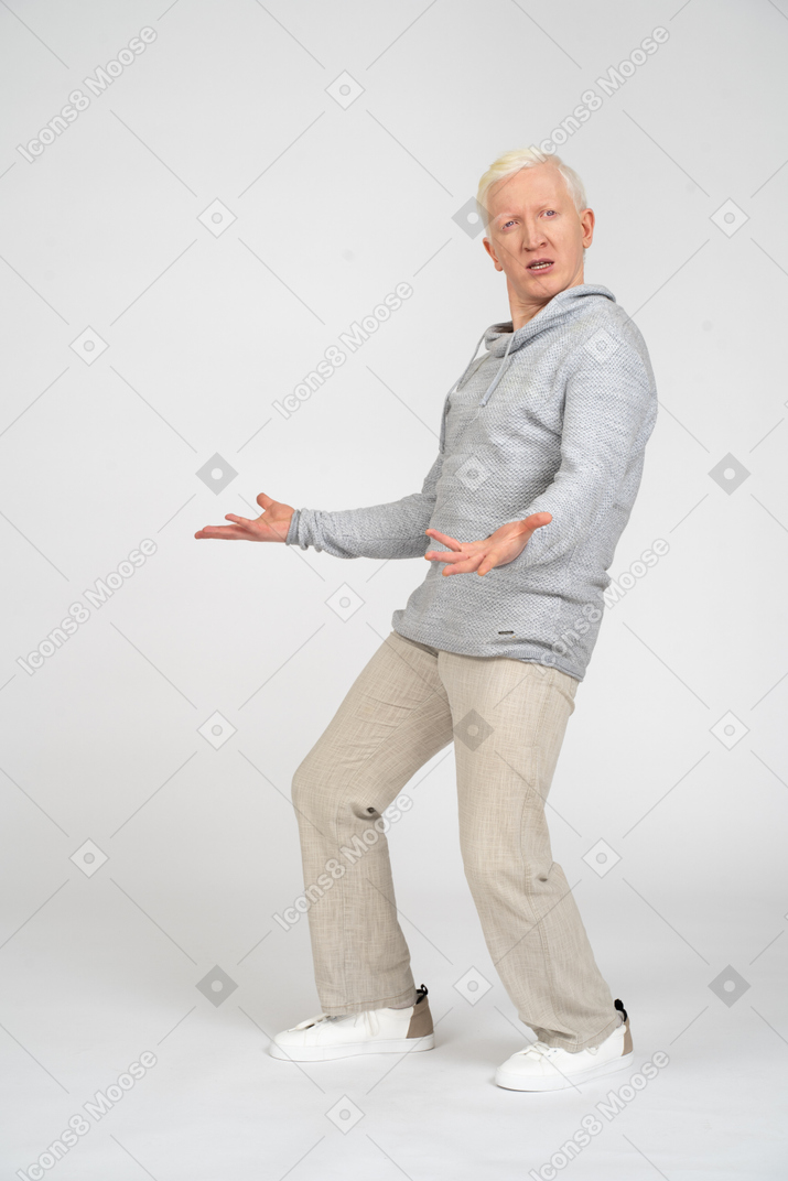 Man standing sideways and spreading his arms