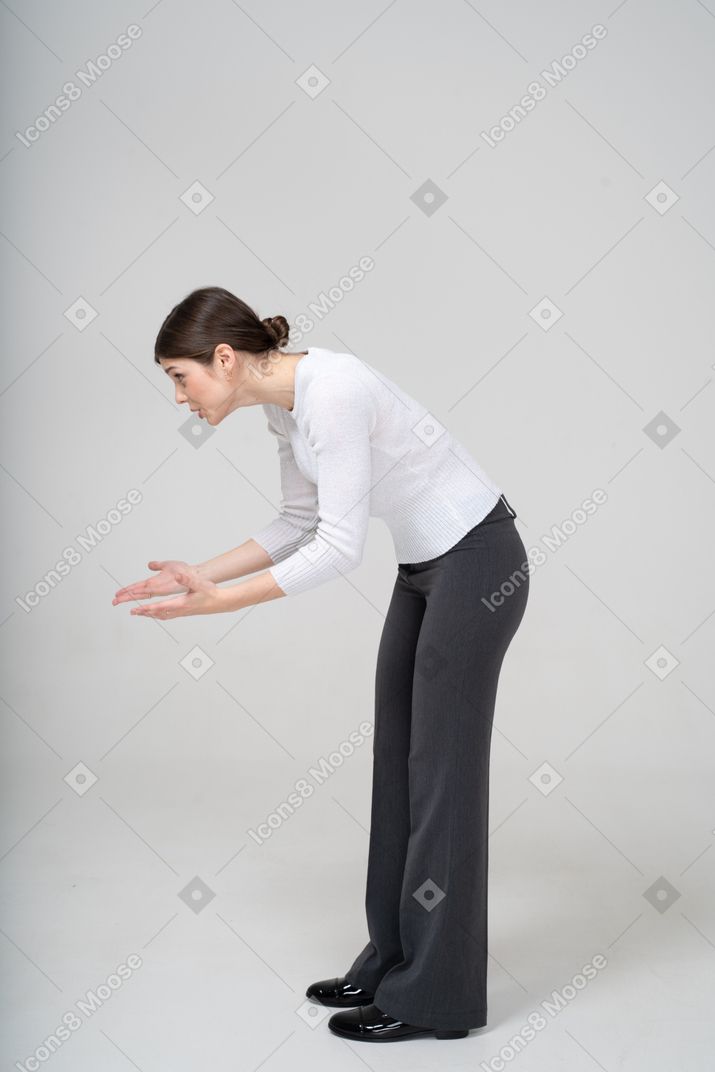 Side view of a woman bending down and explaining something to someone