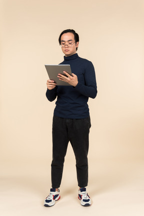 Young asian man holding a digital tablet