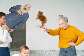 A group of people and a dog standing next to each other