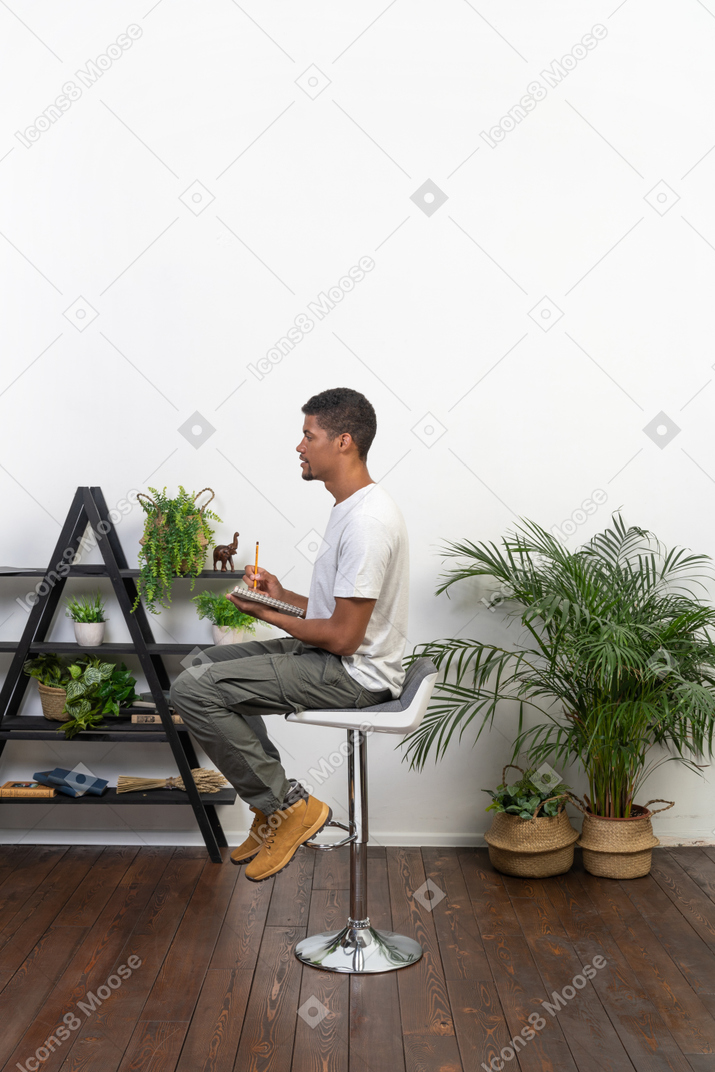Good looking young man sitting on a chair
