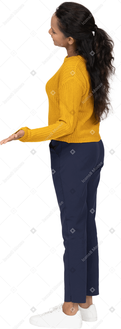Side view of a happy girl in casual clothes making welcome gesture