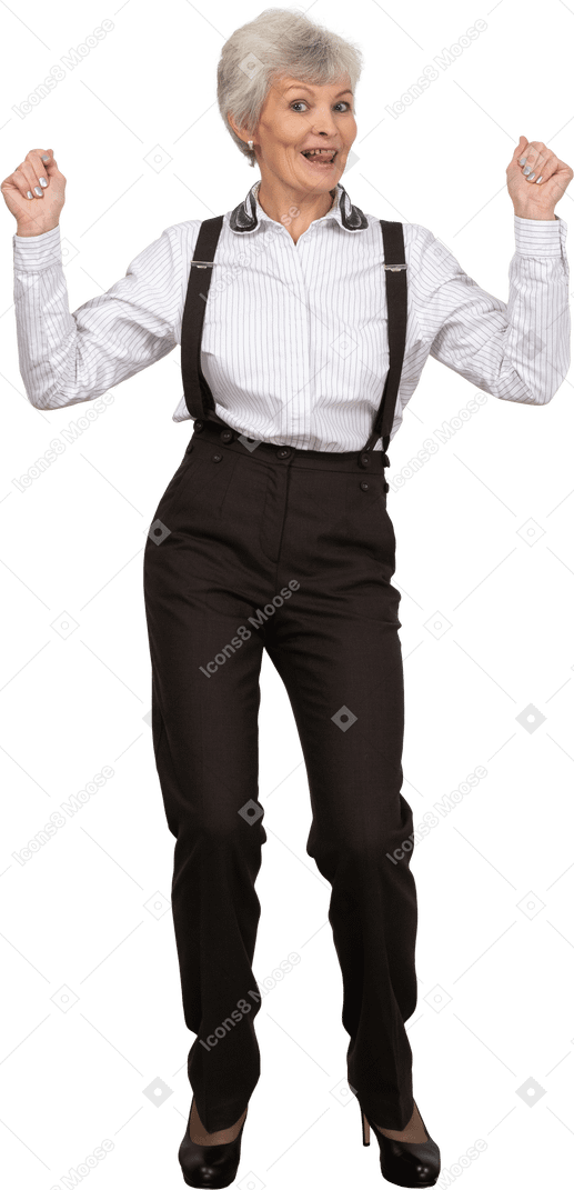 Front view of a happy old lady in office clothing raising hands
