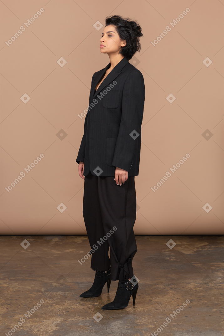 Vista di tre quarti di una donna d'affari scontenta in un abito nero