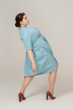 Woman in blue dress posing in profile