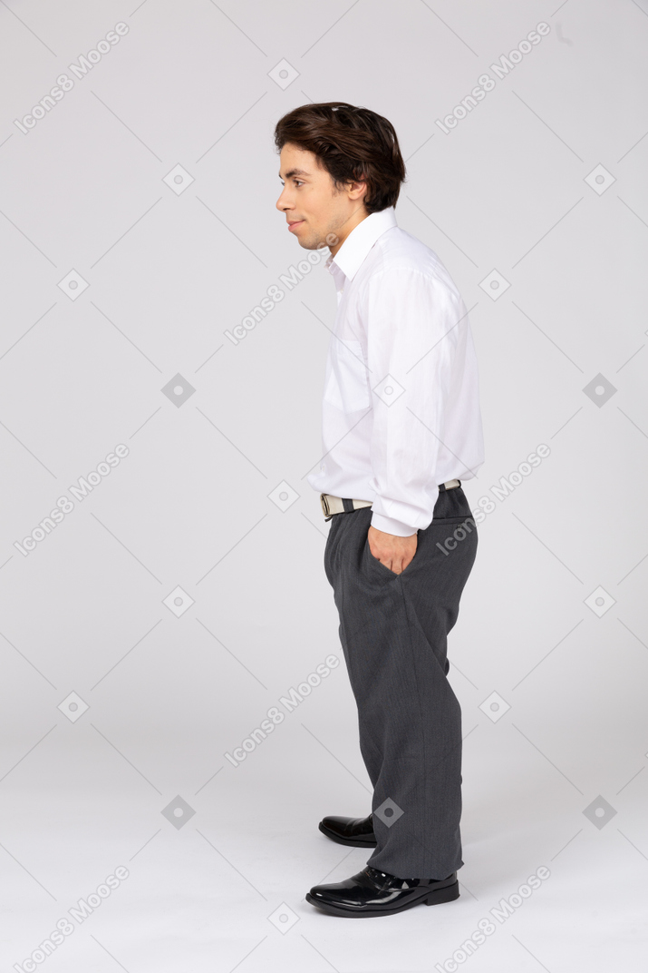 Side view of smiling man with hand in pocket