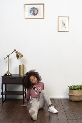 Cute girl kid posing on the apartments background