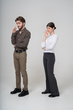 Three-quarter view of a young couple in office clothing smelling unpleasant scent