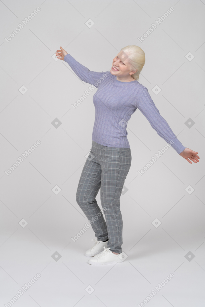 Young woman dancing and spreading arms