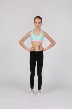 Side view of a teen girl in sportswear raising hand and arguing