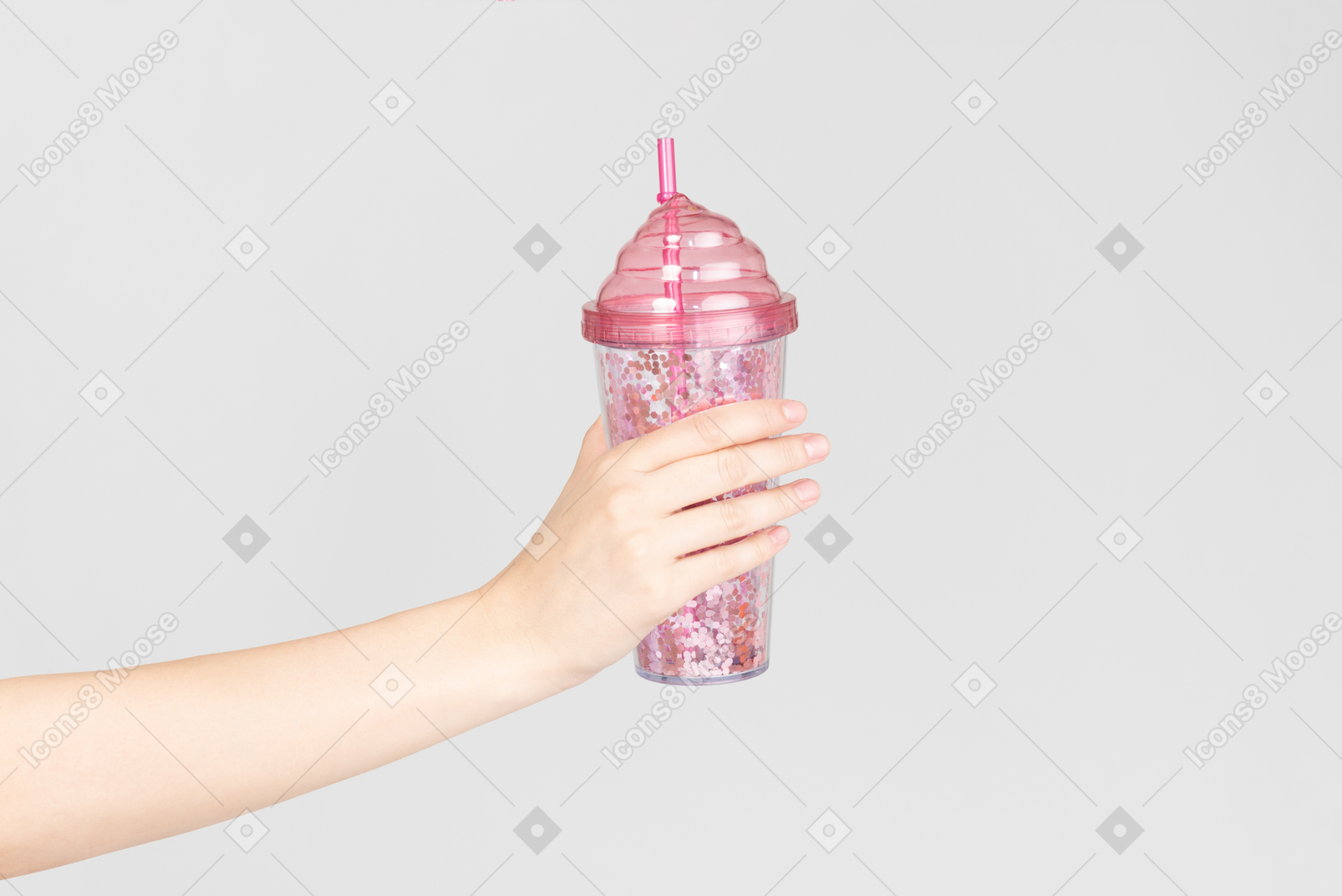 Female hand holding pink plastic cup