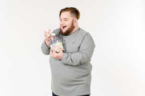 Big bearded guy eating marshmallows with eyes closed