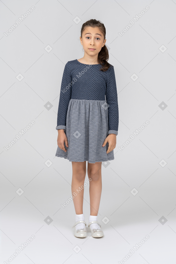 Surprised girl standing with arms at sides and facing the camera
