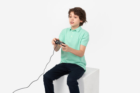 Focused teen boy playing video games