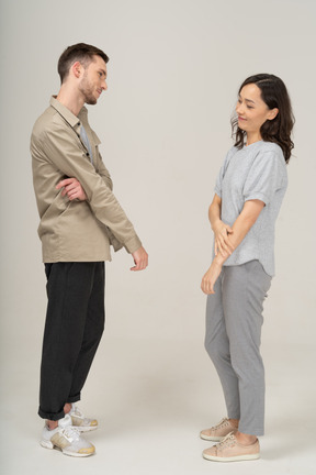 Side view of young couple speaking to each other