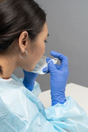 Back view of medical worker wearing mask