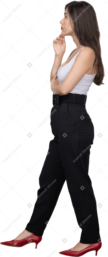 Side view of a young female in office clothing looking thoughtfully aside