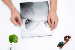 Male hands holding a photo album