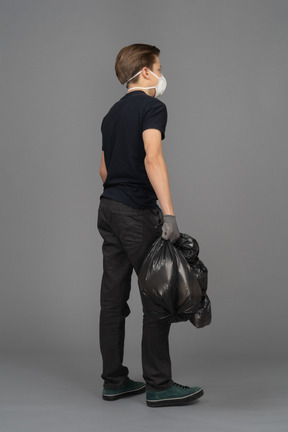 A man holding a black trash bag
