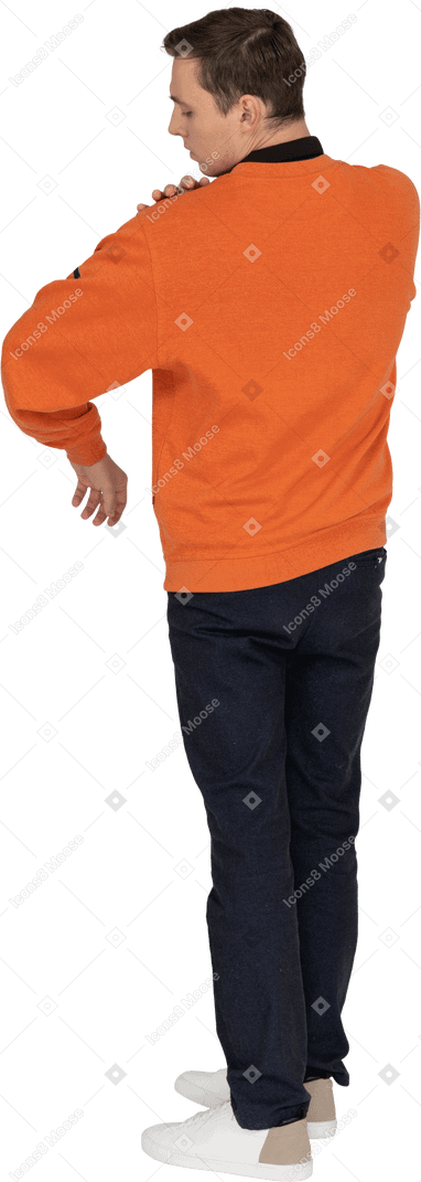 Young man in orange sweatshirt standing