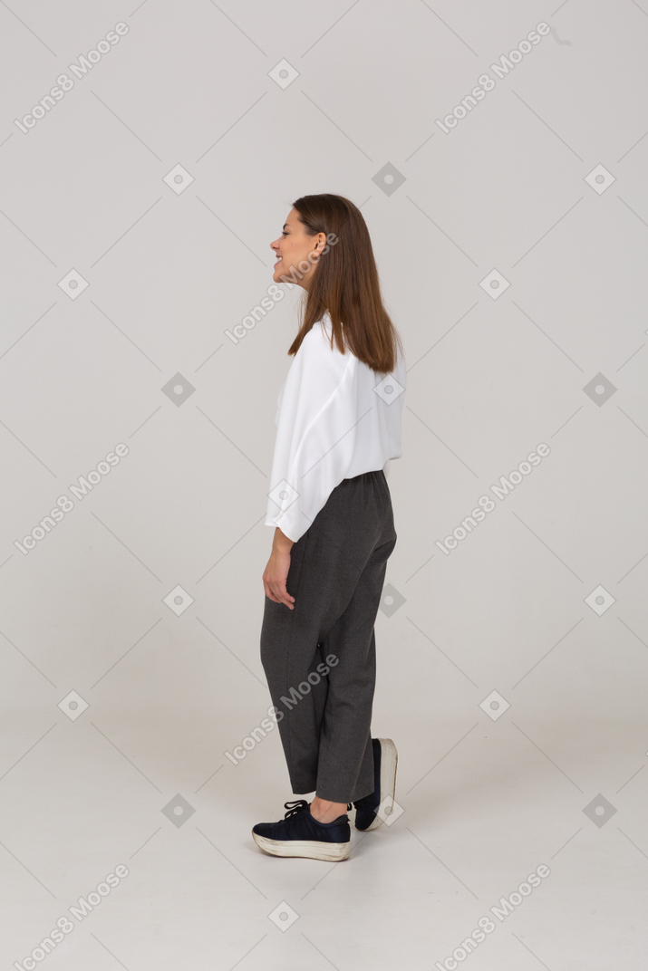 Side view of a young lady in office clothing smiling