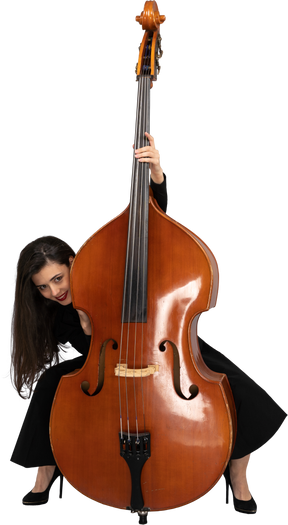 Front view of a crazy young lady squatting behind her double-bass