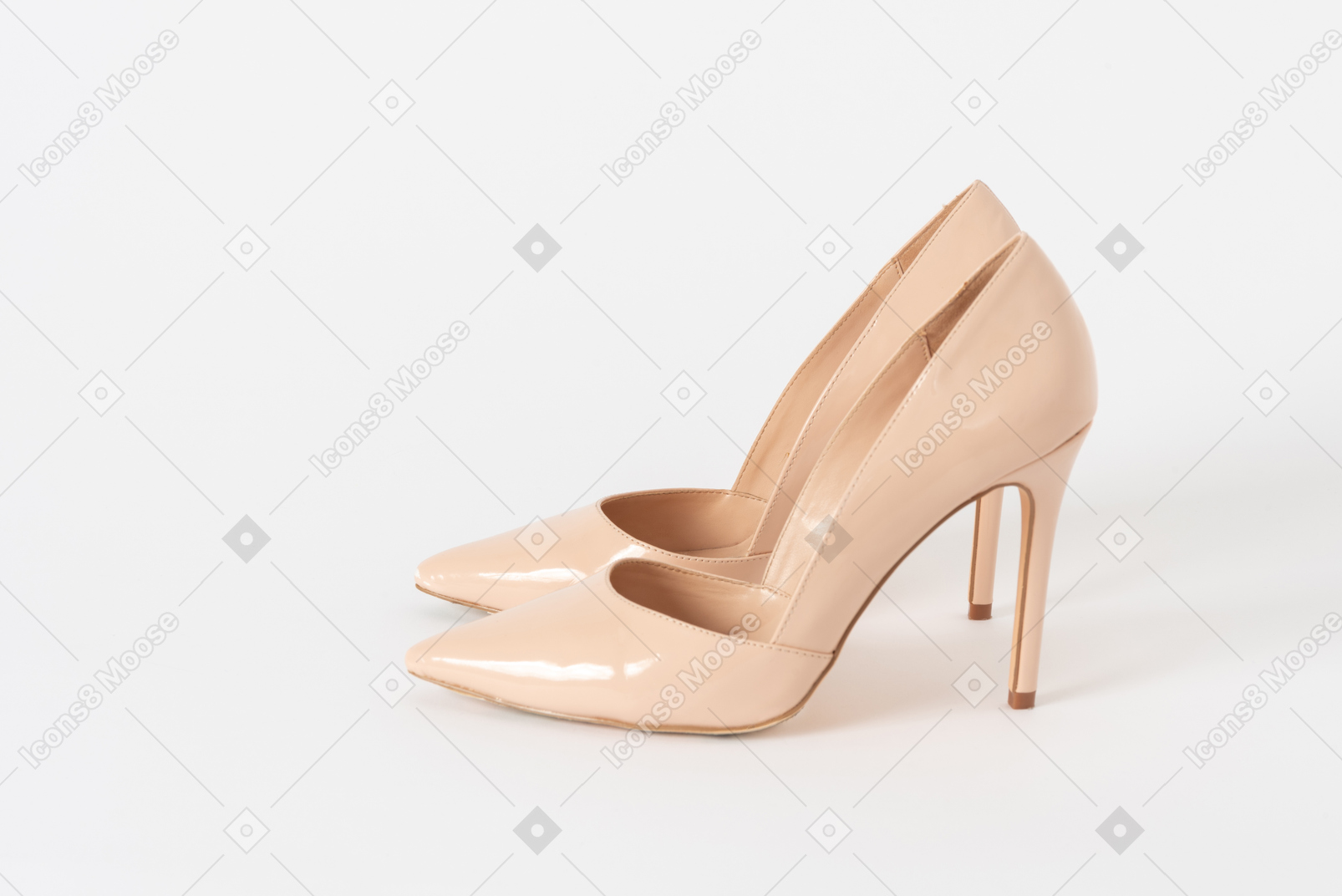A side shot of a pair of beige lacquered stiletto shoes