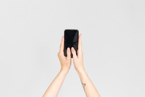 Female hands holding smartphone