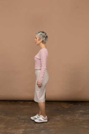 Woman in casual clothes standing in profile