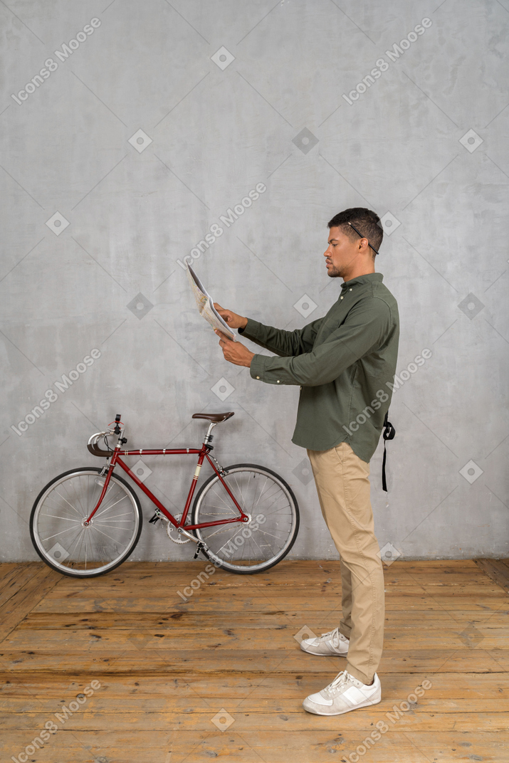 Side view of a man examining a map