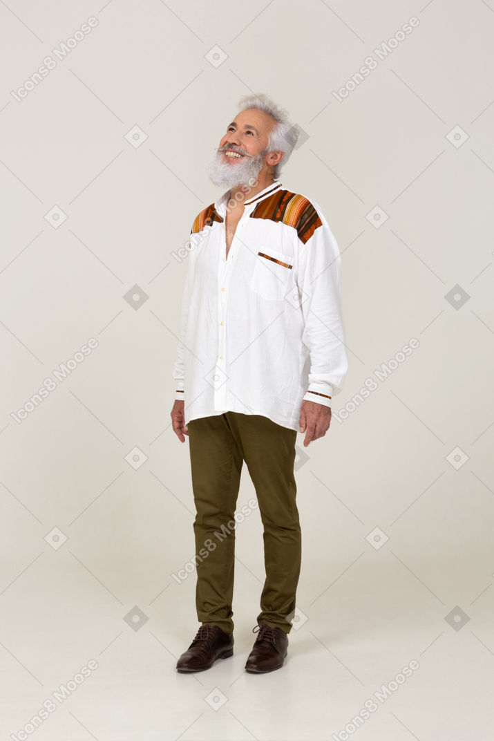 Joyful gray-haired man looking up