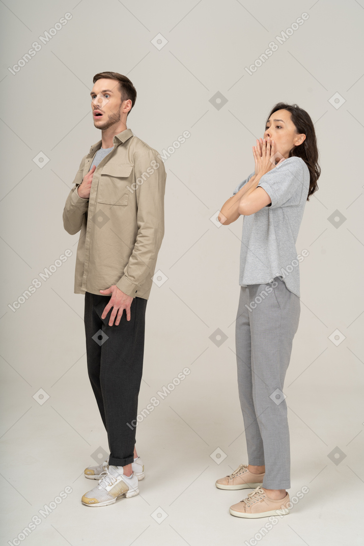Three-quarter view of scared young couple